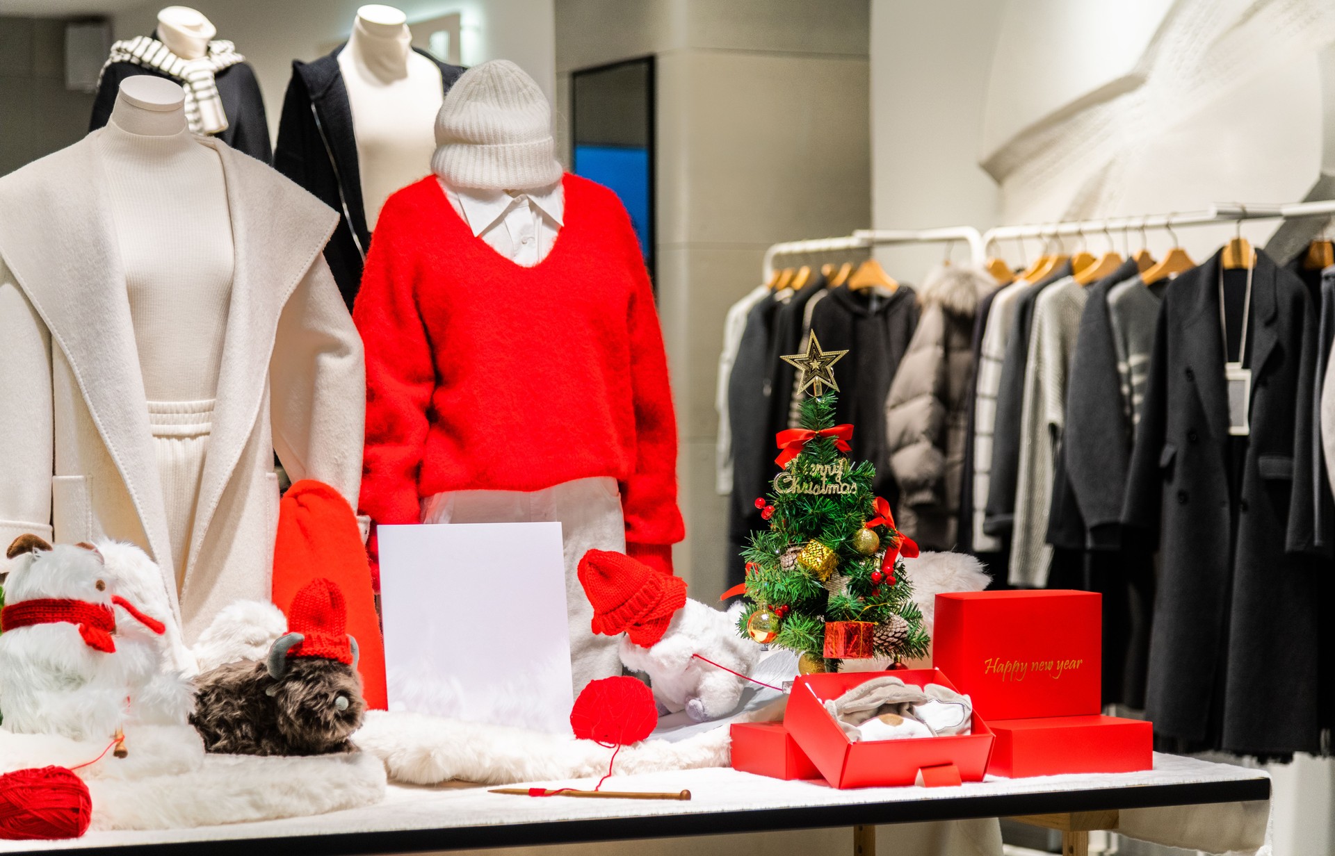 Seasonal winter clothing on retail display with christmas tree decoration